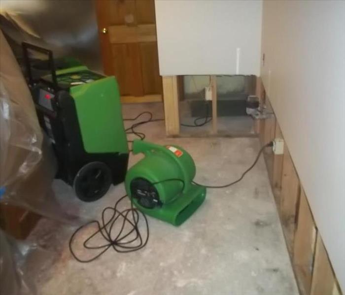 Room with a dehumidifier and air mover in it